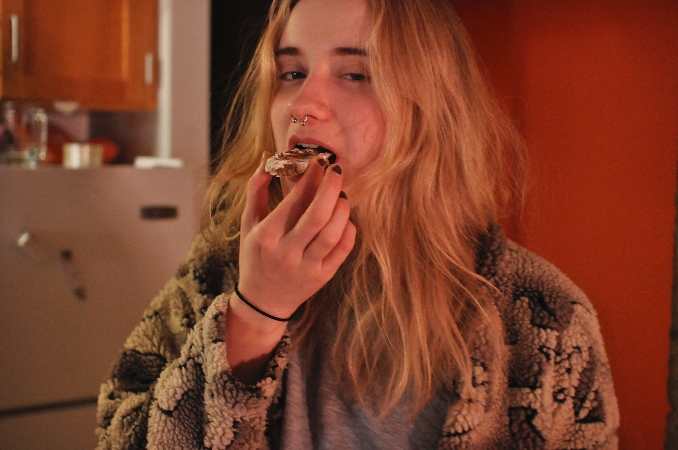 Carrie Rudd eating cricket cookies<br />Photo: Sean Henry-Smith