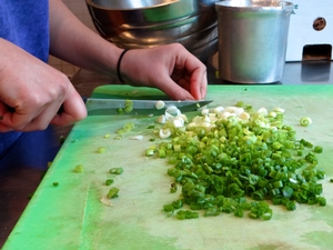 Chopping scallions for the salad
